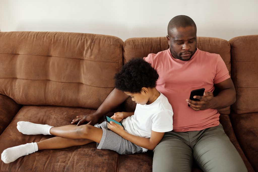 photo of dad and son on couch